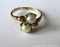 Front view of the vintage 10K yellow gold ring with two round cultured pearls, showing prong settings and ring band detail.