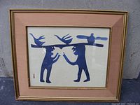 Full frontal view of framed Inuit art print showing two human figures and three birds in silhouette.