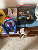 Overview of fitness equipment items including exercise ball box, jump rope, squeeze ball, and fitness tracker.