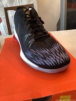 Front top view of the black Nike Zoom Evidence 11 shoe showing mesh upper with white pattern and laces.
