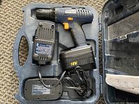 Mastercraft 18V cordless drill with one battery attached and battery charger inside plastic case.