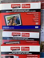 Staples branded photo paper packages, including 100 sheets and 40 sheets professional photo paper packs in unopened packages
