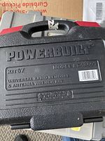 Closed black plastic carrying case with embossed Powerbuilt logo, model and kit number.