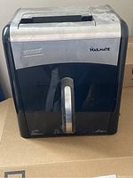 Front view of Staples Mailmate shredder showing brand labels and handle.