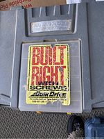 Gray carrying case with Builtright label indicating a cordless drill set with screws and fittings.