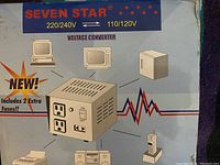 Photo of the front side of the voltage converter box showing brand, voltage rating, and product image on outer packaging.