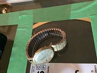 Full view of Jardena watch head and Speidel band on glass surface with MaxSold tag