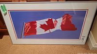 Full view of framed print leaning against wall