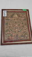 Entire framed textile art piece showing wooden frame and mandala design