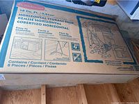 Unopened cardboard box with Rubbermaid branding and product label for 18 Cu Ft Horizontal Storage Shed
