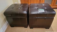 Pair of square dark brown leather storage ottomans side by side, showing overall condition and style