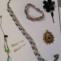 Full lot overview showing choker, bracelet, brooch, necklace, earrings, and hair pins