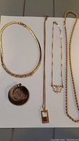 All necklaces and pendant laid flat showing each chain and pendant style and length.