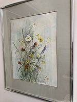 Full view of framed wildflower print with visible mat and silver-tone frame.