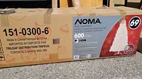 Box labeled NOMA 7 foot lighted white pine tree with 600 mini lights.