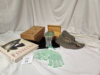Lot displayed showing wooden bait keeper box with twine handle, wooden Field & Stream box, The New Encyclopedia of Fishing book, fishing hat, gloves, and soap in original packaging.