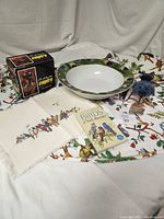 Overview layout of all items showing bowl, binoculars with box, birds tablecloth, guide book, blue bird figure, placemat