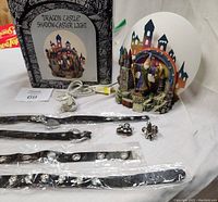 Photo of four black and silver faux leather Gothic necklaces, two silver fleur-de-lis rings, and the Dragon Castle Shadow-Caster light with box, showing all items and their condition.