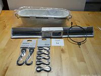 Full lot displayed on table showing pole, bucket, hooks, clips, and cable wire with lot number.