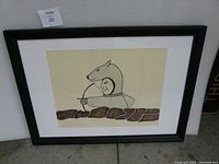 Framed artwork showing hunter in bear costume holding a bow with brown stylized rocks below.