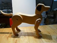 Full side view of the wooden dog decor showing its form and construction.