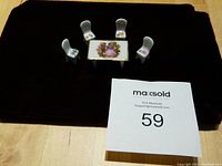 Full set of Limoges mini porcelain table and four chairs on black background