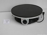 Full view of Presidents Choice electric crepe maker showing round cooking surface and base