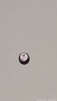 Top view of oval cut natural purple sapphire showcasing transparency and faceting.