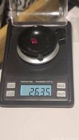 Ruby gemstone on a digital scale showing weight of 2.63 carats.