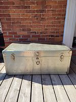 Front view of riveted aluminum trunk with central lock and side latches