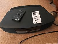 Top view of Bose unit with remote on carpet