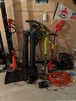Group shot showing all tools including blower/vac, multiple trimmers and hedge trimmer with charger and cords