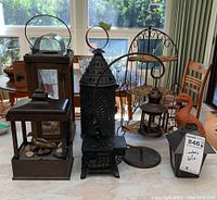 Front view of four lanterns on counter, wire mini shelf, terra cotta duck, and plastic fountain