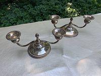 Pair of candlestick holders shown side by side on tabletop
