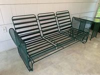 Right-angled view of empty metal frame glider sofa