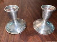 Pair of Towle sterling silver weighted reinforced candlestick holders, showing overall shape and size.