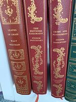 Spines of Leaves of Grass, The Brothers Karamazov, and Crime and Punishment showing maroon leather covers with gold embossing.