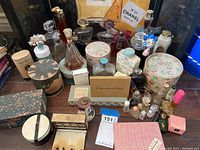 Overview of vintage perfume and toiletry bottles including boxed items and loose bottles with stoppers.