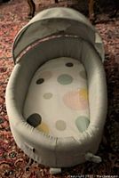New LulyBoo infant travel lounger with canopy, showing overall view and interior mattress with colorful polka dots.