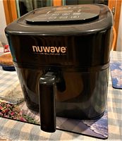 Front view of black NuWave Brio air fryer with handle and visible digital control panel.