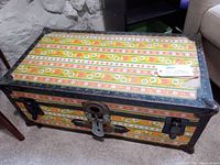 Photo of the vintage foot locker showing colorful patterned exterior and metal edges