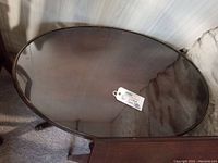 Top view of the vintage oval coffee table showing the glass top and wooden frame.