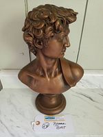 Front and side views of the resin Roman bust from multiple angles showing detailed hair, facial profile, and shoulder drapery.