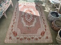 Full view of the Goldsun floral area rug showing central medallion design and border with pink and rose floral accents.