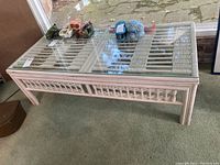 Front angle view of the bentwood coffee table showing glass top and woven bentwood pattern beneath.