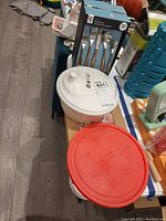 Photo showing New City flatware box, salad spinner lid, ceramic board, and cheese markers.