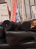 Close-up of front lens and carrying case of Bushnell binoculars