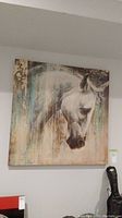 Front view of unframed canvas print depicting a horse's head with textured paint drip effects on a muted background.