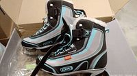 Pair of Dr Flowline ice skates inside an open box, showing the right and left skates side by side.