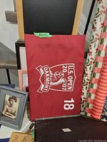 Photo of the maroon U.S. Open 2007 18th hole flag with white writing and logo, measuring approx 20x12 inches.